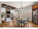Breakfast nook features a wood table with stainless steel refrigerator and natural light at 13142 Overlook Pass, Roswell, GA 30075