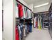 Walk-in closet with custom shelving, hanging racks, ample storage space for clothing and accessories at 13142 Overlook Pass, Roswell, GA 30075