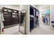 Spacious walk-in closet featuring wood shelving, drawers, full length mirror, and carpeted floors at 13142 Overlook Pass, Roswell, GA 30075