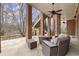 Covered patio with brick pillars and ceiling fans, a comfortable outdoor seating area at 13142 Overlook Pass, Roswell, GA 30075