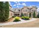 Elegant home with a brick facade, well-maintained lawn, and a charming covered entryway at 13142 Overlook Pass, Roswell, GA 30075