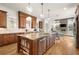 Open kitchen featuring custom cabinets, a large island, and stainless steel appliances at 13142 Overlook Pass, Roswell, GA 30075