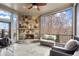 Inviting covered patio with a stone fireplace, comfortable seating, and an outdoor view at 13142 Overlook Pass, Roswell, GA 30075