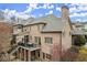 Expansive brick home with outdoor living space, featuring a covered deck and lush landscaping at 13142 Overlook Pass, Roswell, GA 30075