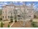 Large brick home with multiple windows, beautiful landscaping, and outdoor entertaining areas at 13142 Overlook Pass, Roswell, GA 30075