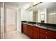 Bright Primary bathroom featuring a dual vanity with wood cabinets and a large mirror at 195 14Th Ne St # Ph 306, Atlanta, GA 30309