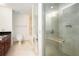 Primary bath with glass shower, tile surround, and vanity with dark countertop at 195 14Th Ne St # Ph 306, Atlanta, GA 30309
