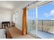 Bright bedroom featuring balcony access with sliding glass doors and custom window treatments at 195 14Th Ne St # Ph 306, Atlanta, GA 30309