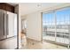 Bright dining area with tile flooring, large windows, and a sliding glass door to balcony with city view at 195 14Th Ne St # Ph 306, Atlanta, GA 30309