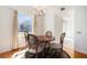 Cozy dining area with hardwood floors, a round table with seating for four, and a large window at 195 14Th Ne St # Ph 306, Atlanta, GA 30309