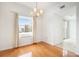Cozy dining area features hardwood floors, chandelier lighting, and city views at 195 14Th Ne St # Ph 306, Atlanta, GA 30309