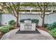 Outdoor grill area surrounded by landscaping, hardscape, and shade trees at 195 14Th Ne St # Ph 306, Atlanta, GA 30309