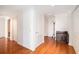 Hallway with hardwood floors, fresh white paint and trim, closet doors, and vintage chest at 195 14Th Ne St # Ph 306, Atlanta, GA 30309