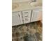 Bathroom with dual vanities and granite tile flooring at 2695 Lindsey Oak Ln, Lawrenceville, GA 30044