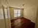 Bedroom with wood floors, neutral walls, and a bright window at 2695 Lindsey Oak Ln, Lawrenceville, GA 30044