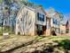 Two-story home featuring brick and vinyl siding, a landscaped front yard, and a two-car garage at 2695 Lindsey Oak Ln, Lawrenceville, GA 30044