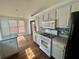 Bright kitchen with white cabinets, modern appliances, and wood floors at 2695 Lindsey Oak Ln, Lawrenceville, GA 30044