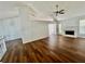 Bright living room featuring hardwood floors, a ceiling fan, fireplace, and natural light at 2695 Lindsey Oak Ln, Lawrenceville, GA 30044