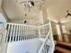 Bright and airy living room with hardwood floors, direct access to stairs, and a chandelier at 2695 Lindsey Oak Ln, Lawrenceville, GA 30044