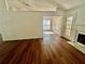 Living room featuring hardwood floors, a fireplace, ceiling fan, and plenty of natural light at 2695 Lindsey Oak Ln, Lawrenceville, GA 30044