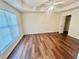 Spacious main bedroom features a tray ceiling, fan, and hardwood floors at 2695 Lindsey Oak Ln, Lawrenceville, GA 30044