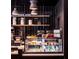 Interior shot of a cafe featuring a sleek display case with various pastries and shelving at 45 Ivan Allen Jr Nw Blvd # 1704, Atlanta, GA 30308