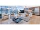 Bright living room with large windows, modern furniture, and a sleek kitchen in the background at 45 Ivan Allen Jr Nw Blvd # 1704, Atlanta, GA 30308