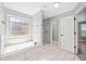 Bathroom featuring a soaking tub, glass shower, and tiled floors at 50 Riverstone Dr, Covington, GA 30014