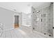 Modern bathroom featuring a glass shower, a soaking tub and tiled floors at 50 Riverstone Dr, Covington, GA 30014