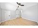 Light, airy bedroom with neutral walls, fan, and hardwood floors leading to a closet at 50 Riverstone Dr, Covington, GA 30014