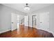 Spacious bedroom featuring hardwood floors and access to multiple doorways and a connecting bathroom at 50 Riverstone Dr, Covington, GA 30014