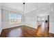 Open dining area with large window, designer lighting, and clear view to the eat-in kitchen at 50 Riverstone Dr, Covington, GA 30014