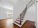 Spacious foyer features hardwood floors, a staircase, and a view into adjacent living spaces at 50 Riverstone Dr, Covington, GA 30014