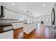 Spacious kitchen with white cabinets, dark countertops, and stainless steel appliances at 50 Riverstone Dr, Covington, GA 30014