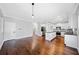 Open-concept kitchen featuring granite counters, white cabinetry, stainless appliances, and a central island at 50 Riverstone Dr, Covington, GA 30014