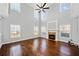 Bright living room featuring soaring ceilings, a ceiling fan, and a decorative fireplace with mantle at 50 Riverstone Dr, Covington, GA 30014