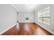 Sunlit living room boasting hardwood floors, neutral walls, and a large window at 50 Riverstone Dr, Covington, GA 30014