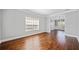 Bright living room with hardwood floors, large window, and elegant molding with open access to a dining room at 50 Riverstone Dr, Covington, GA 30014