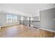 Upstairs loft area with railing overlooking the living area featuring light-colored hardwood floors and many windows at 50 Riverstone Dr, Covington, GA 30014