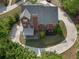 Aerial view of the home featuring a deck, patio, and a circular driveway at 711 Wilhaven Ct, Loganville, GA 30052