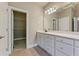 Bathroom with tiled flooring and a white vanity with many cabinets and drawers for plenty of storage at 711 Wilhaven Ct, Loganville, GA 30052