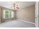 Bedroom with a ceiling fan, a window for natural light, and a closet for storage at 711 Wilhaven Ct, Loganville, GA 30052