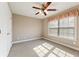 Bedroom with a ceiling fan, natural light from the window, and closet for storage at 711 Wilhaven Ct, Loganville, GA 30052