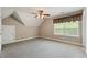 Bright bedroom with a large window, neutral walls, and ceiling fan at 711 Wilhaven Ct, Loganville, GA 30052