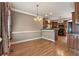 The dining room features hardwood floors, neutral walls and an elegant chandelier at 711 Wilhaven Ct, Loganville, GA 30052
