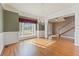 Dining room features hardwood floors, chandelier, and view into the front hallway at 711 Wilhaven Ct, Loganville, GA 30052