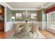Bright dining room featuring hardwood floors and neutral-toned furnishings at 711 Wilhaven Ct, Loganville, GA 30052