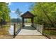 Beautiful lake dock featuring seating with lattice railing and a lush green shoreline at 711 Wilhaven Ct, Loganville, GA 30052