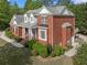Rear exterior view of a brick home with an attached garage and a well-maintained yard at 711 Wilhaven Ct, Loganville, GA 30052