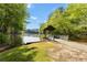 Beautiful lake view featuring a covered dock, lush trees, and a serene atmosphere at 711 Wilhaven Ct, Loganville, GA 30052